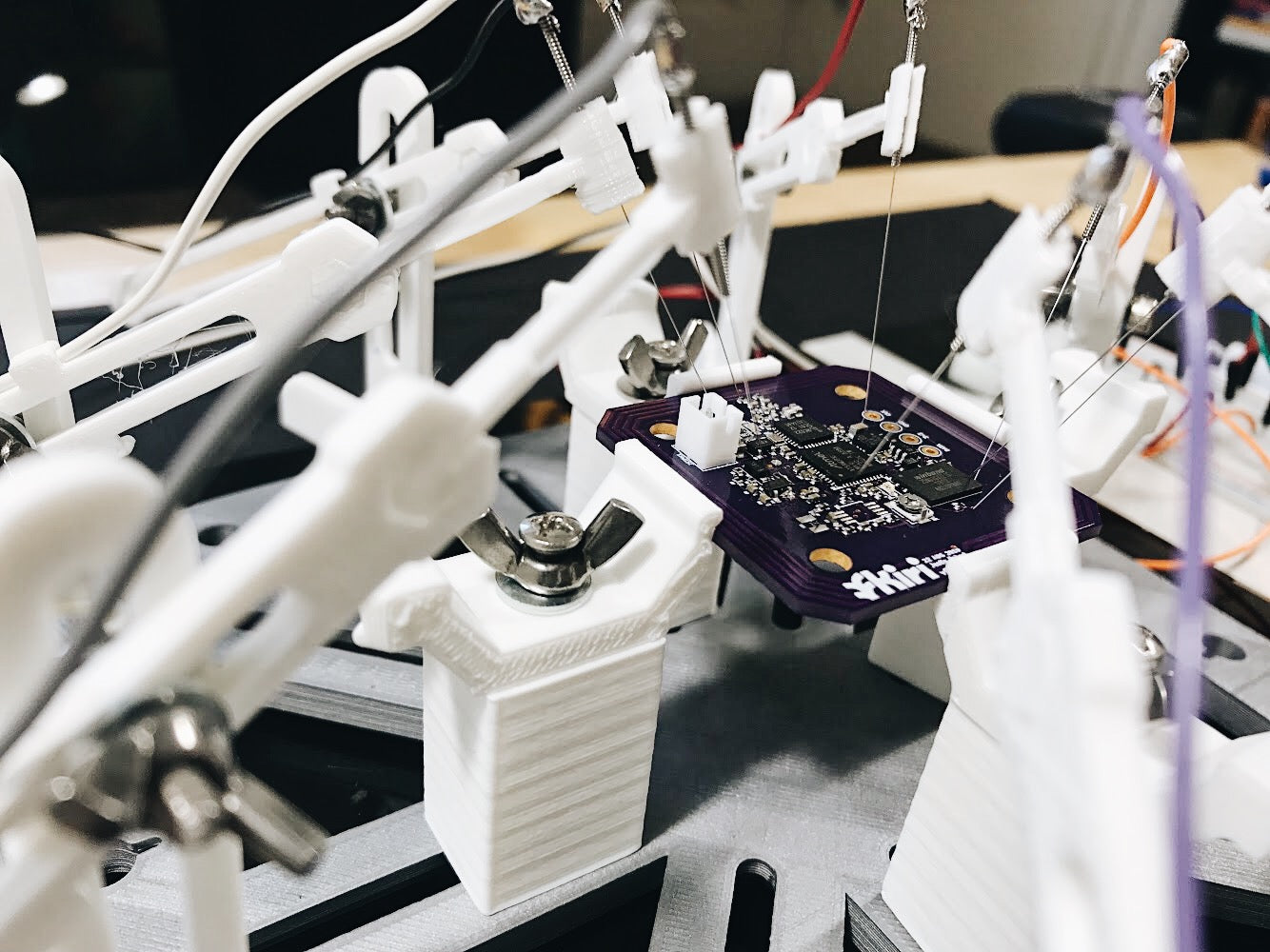 A chip, small wires, and other components inside the Kiri Smart Block