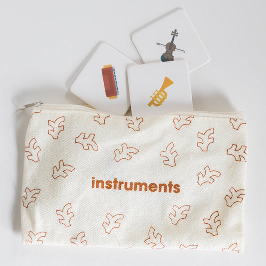 Cloth zippered Instruments Tile Pack pouch on white background with four tiles spilling out