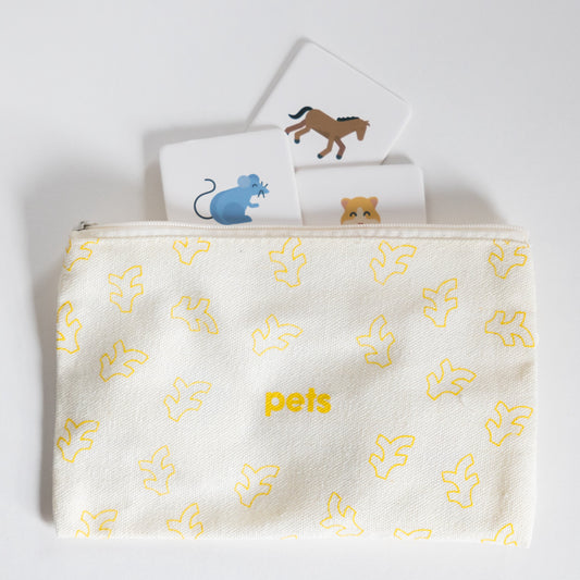Cloth zippered Pets Tile Pack pouch on white background with four tiles spilling out