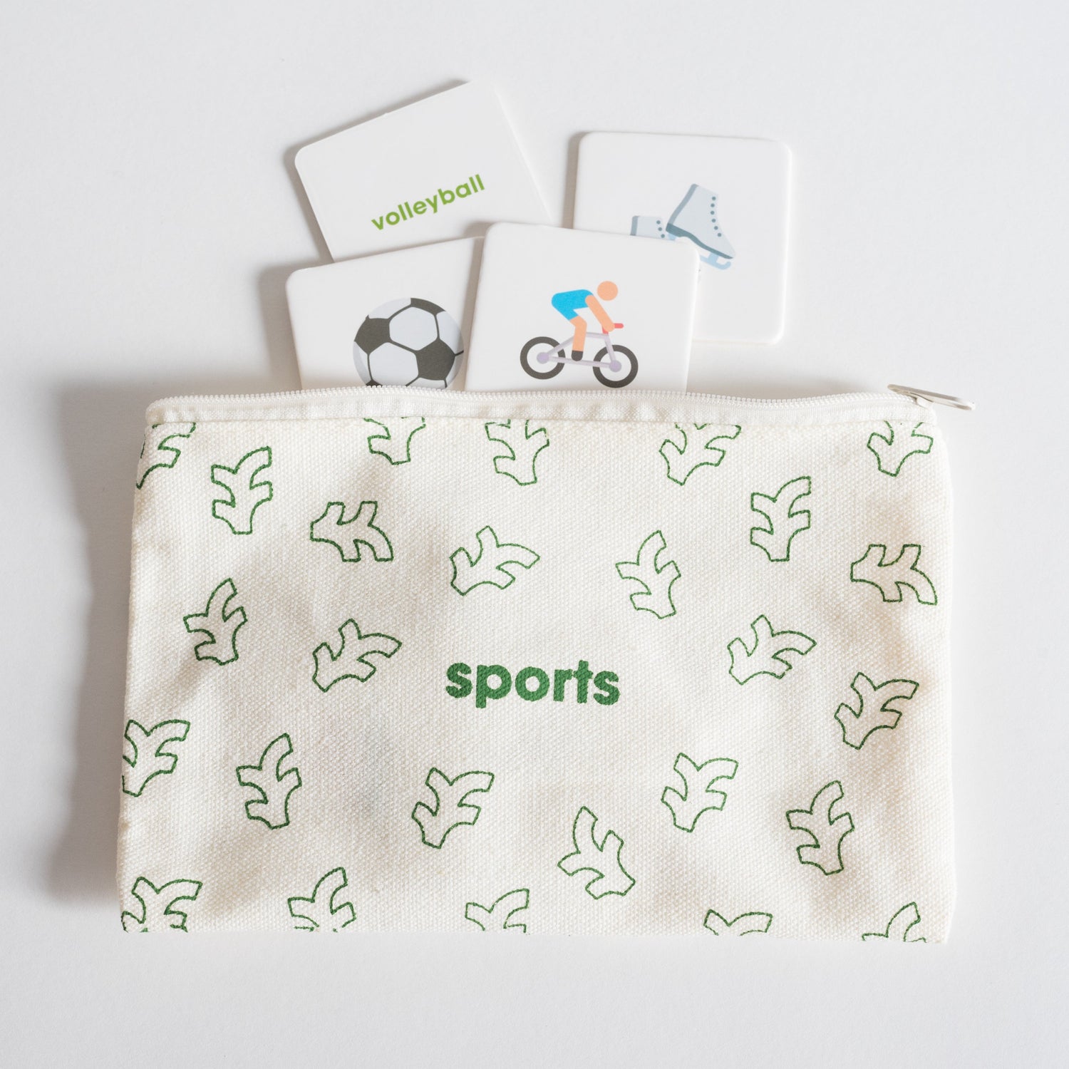 Cloth zippered Sports Tile Pack pouch on white background with four tiles spilling out